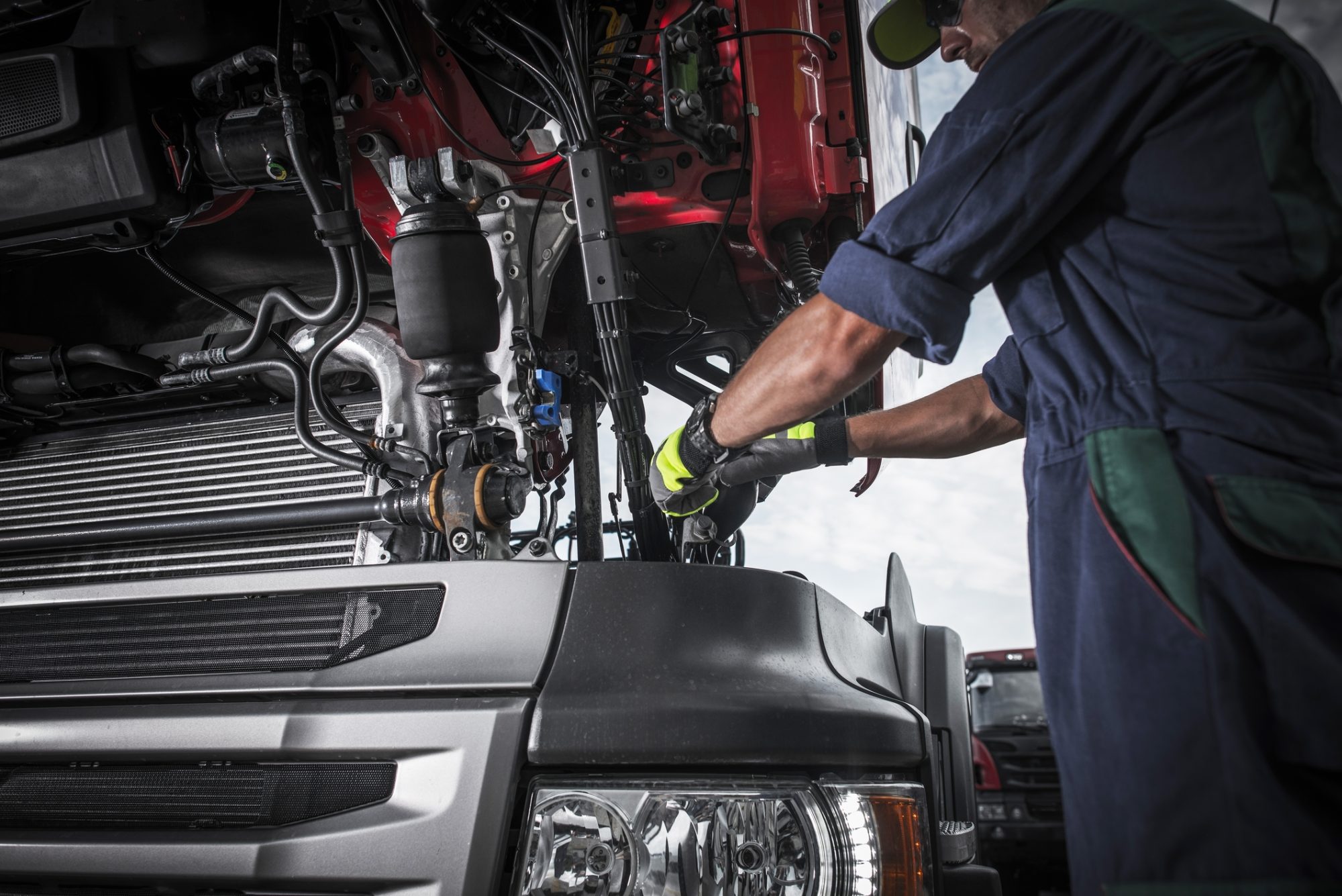 Repairing Broken Semi Truck Tractor Engine. Caucasian Trucks Mechanic.