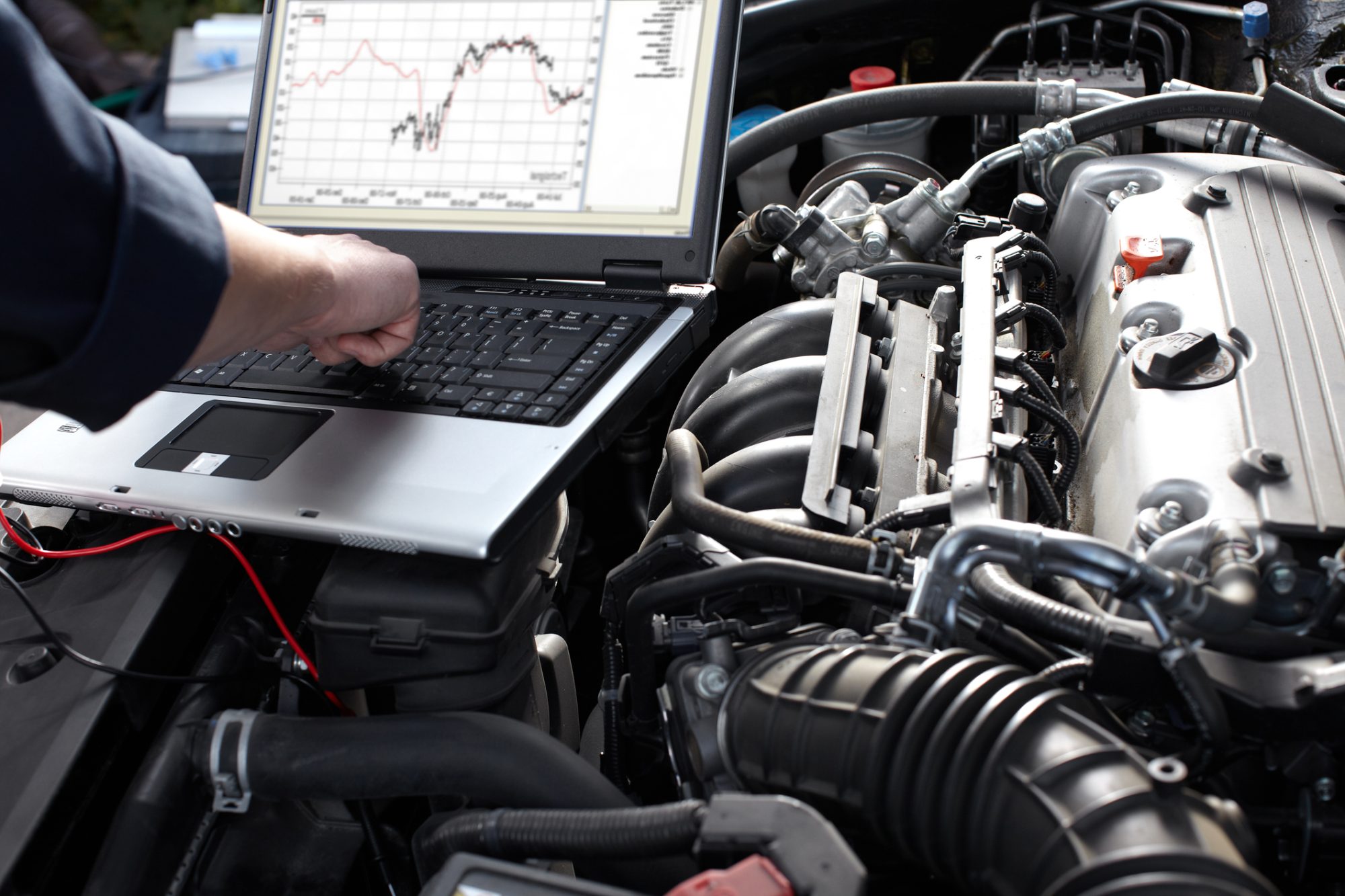 Professional car mechanic working in auto repair service.